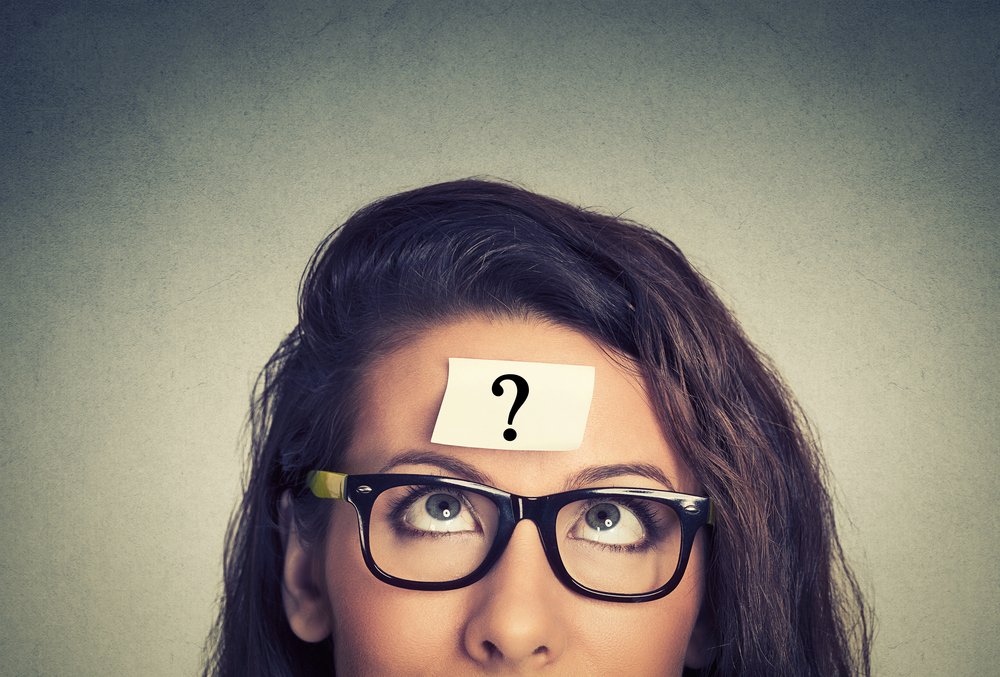 thinking woman with question mark on gray wall background-1