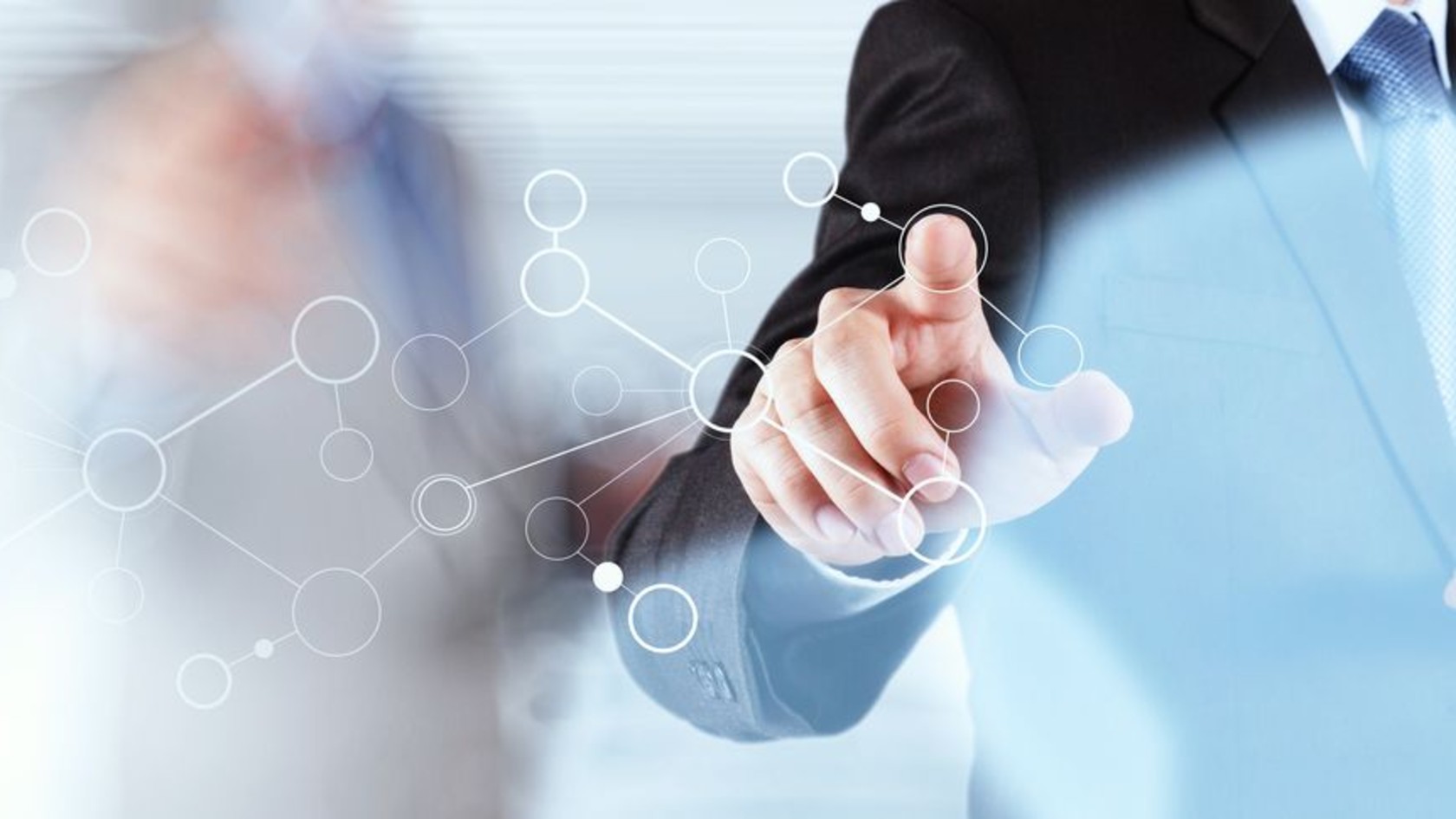 A business professional touching a digital network diagram, representing a CISO overseeing an organisation’s information security.