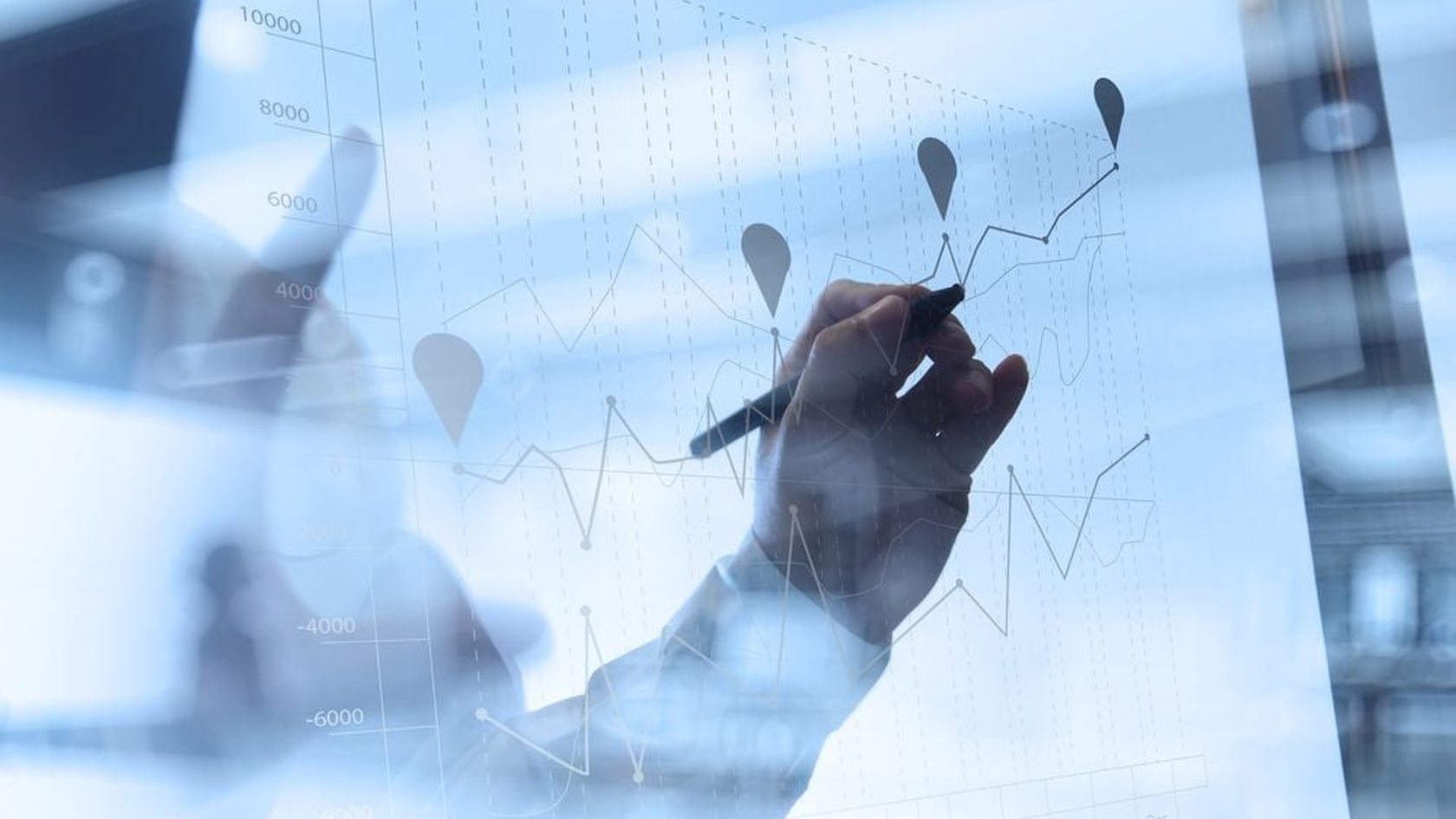 Hand drawing a strategy chart on glass, illustrating planning and progress in NIST framework implementation.